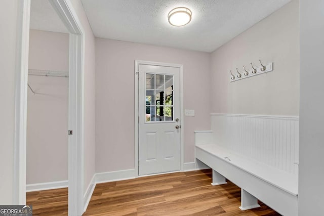 mudroom with a textured ceiling and wood-type flooring