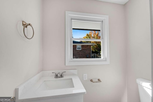 bathroom featuring vanity and toilet