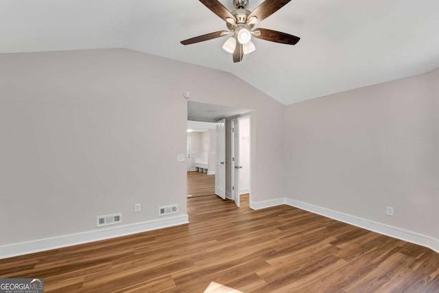 spare room with ceiling fan, hardwood / wood-style flooring, and vaulted ceiling