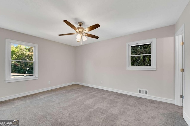 unfurnished room featuring light carpet and ceiling fan