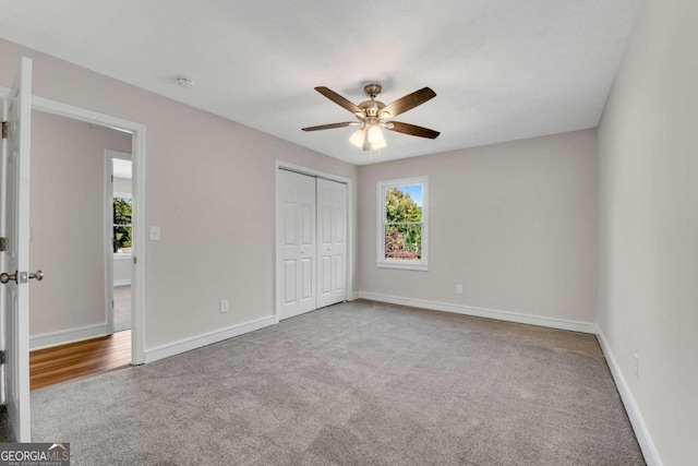 unfurnished bedroom with light carpet, a closet, and ceiling fan