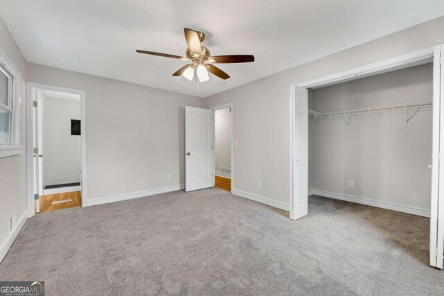 unfurnished bedroom featuring light carpet, a closet, and ceiling fan