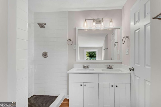 bathroom featuring vanity and tiled shower