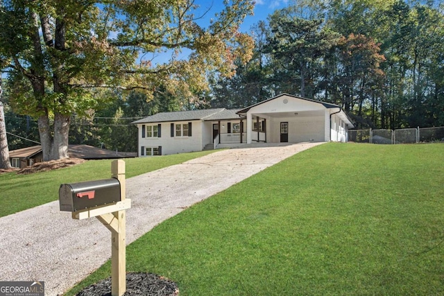 ranch-style house featuring a garage and a front lawn