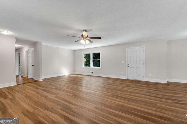 unfurnished room featuring a textured ceiling, ceiling fan, and dark hardwood / wood-style flooring