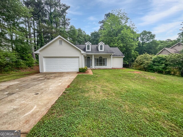 view of front of property featuring a front yard and a garage