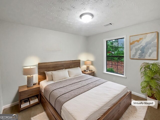 bedroom with ceiling fan and light colored carpet