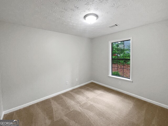 spare room featuring carpet floors and ceiling fan