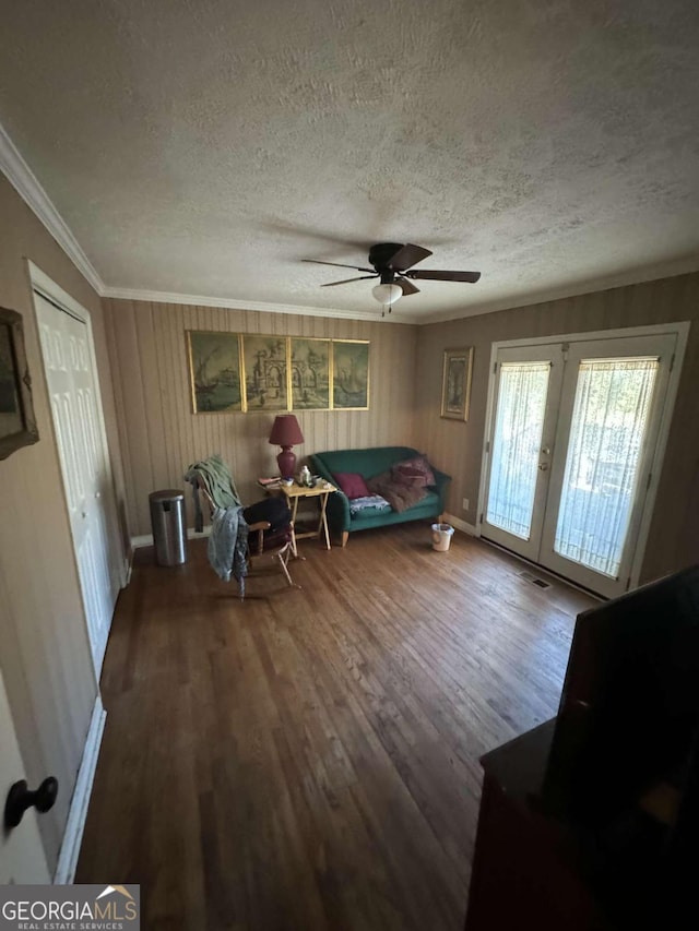 living room with french doors, a textured ceiling, hardwood / wood-style floors, ceiling fan, and crown molding