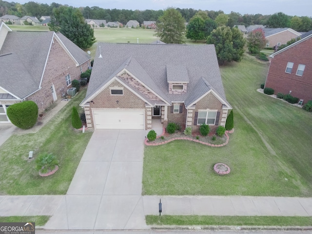 view of front facade with a front lawn, central AC unit, and a garage