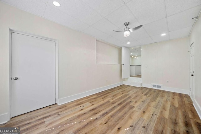 unfurnished room featuring ceiling fan, light hardwood / wood-style flooring, and a paneled ceiling