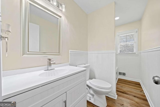 bathroom featuring vanity, hardwood / wood-style floors, and toilet