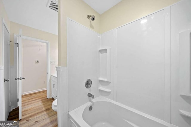 full bathroom featuring vanity, hardwood / wood-style floors, toilet, and shower / bathtub combination