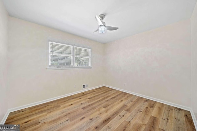 spare room with light hardwood / wood-style floors and ceiling fan