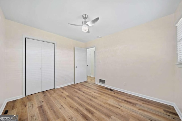 unfurnished bedroom featuring a closet, ceiling fan, and light hardwood / wood-style flooring