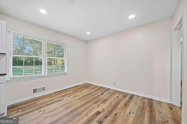 unfurnished room featuring light hardwood / wood-style floors