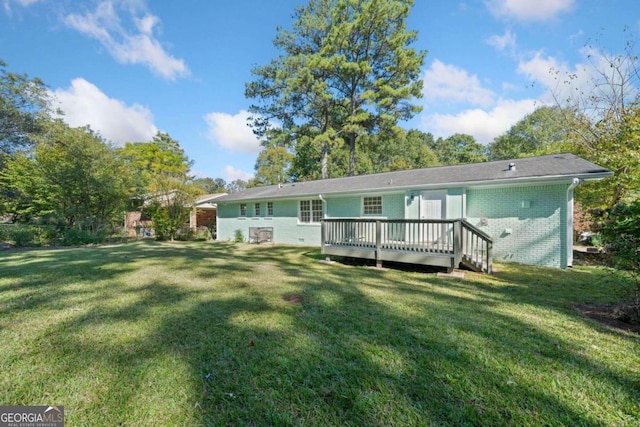 back of property featuring a yard and a deck