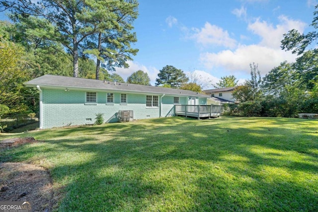 back of house featuring a yard and a deck