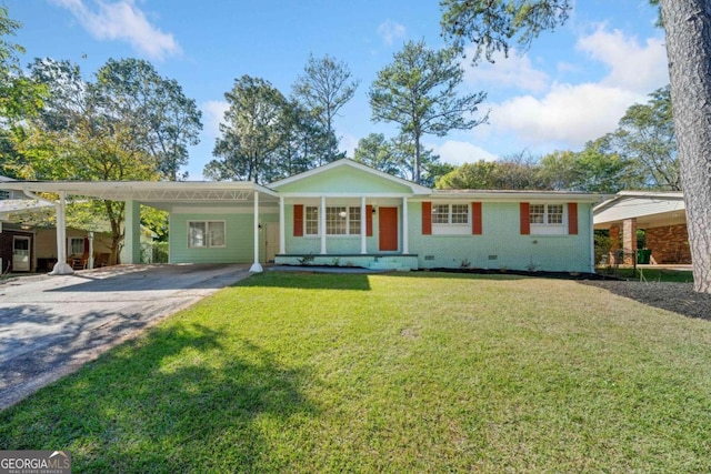 ranch-style home featuring a front lawn and a carport