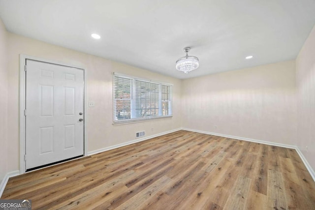 interior space with light hardwood / wood-style flooring and a chandelier