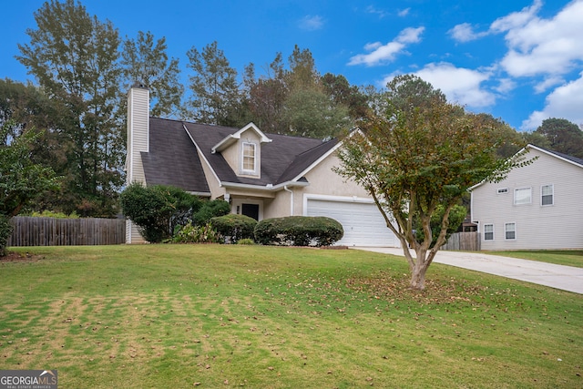 view of front of house with a garage and a front yard