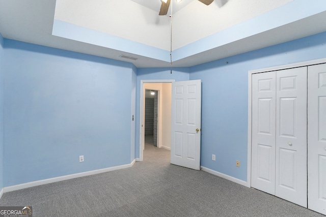 unfurnished bedroom featuring a closet, carpet flooring, and ceiling fan