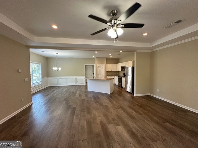 unfurnished living room with crown molding, dark hardwood / wood-style floors, ceiling fan with notable chandelier, and a raised ceiling