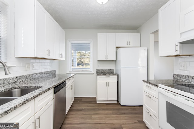 kitchen featuring sink, light stone counters, dark hardwood / wood-style flooring, white appliances, and white cabinets