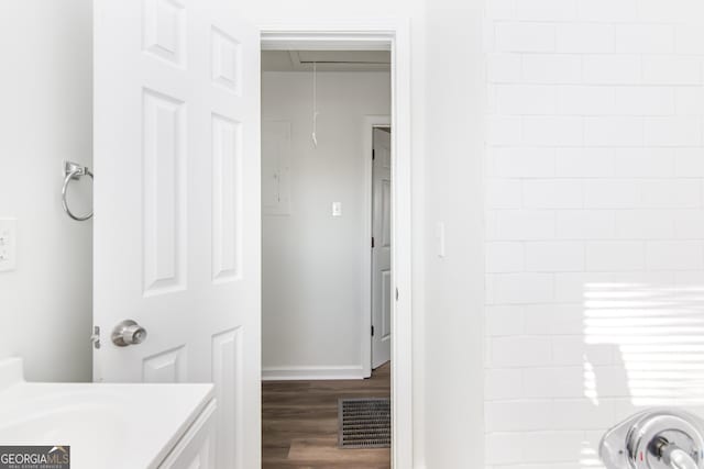 bathroom featuring a shower, hardwood / wood-style floors, and vanity