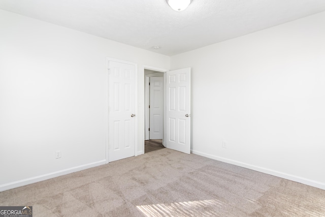 spare room with light carpet