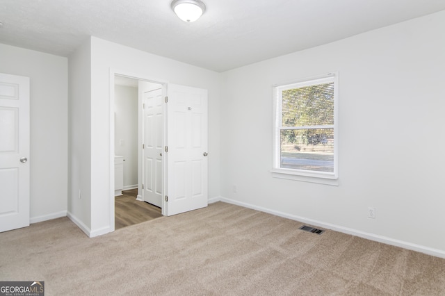 unfurnished bedroom featuring carpet flooring