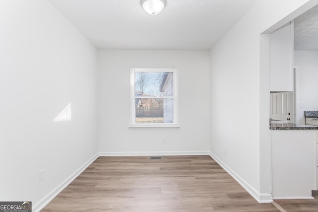 empty room with light hardwood / wood-style floors