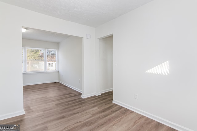 empty room featuring hardwood / wood-style floors and a textured ceiling