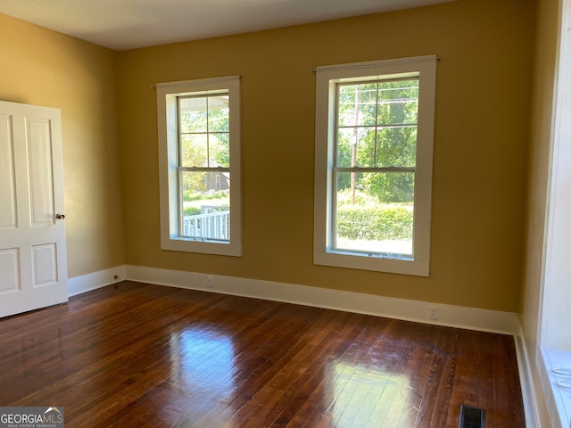 empty room featuring dark hardwood / wood-style flooring