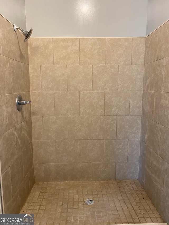 bathroom with a tile shower