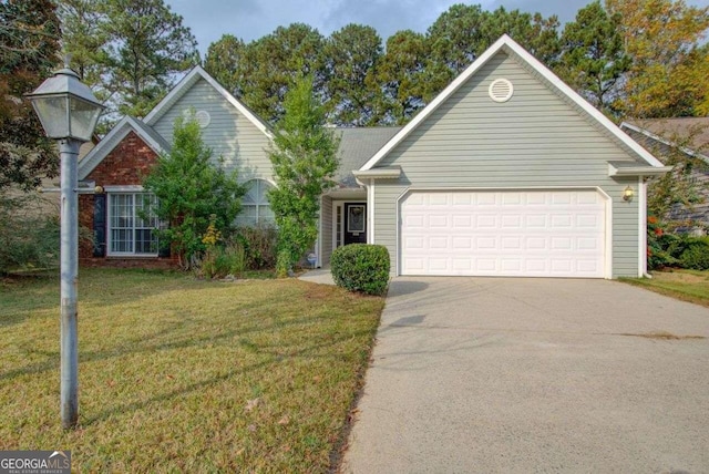 view of front of house featuring a front lawn and a garage