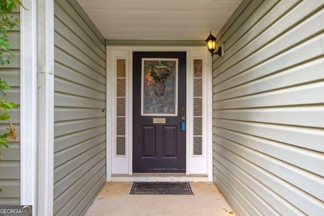 view of exterior entry with covered porch