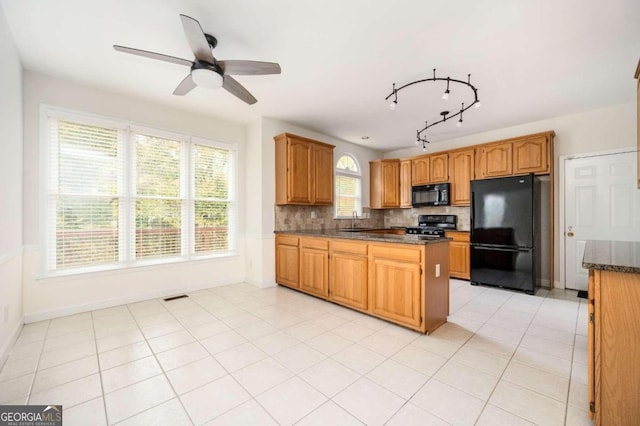 kitchen with ceiling fan, black appliances, light tile patterned flooring, and decorative backsplash