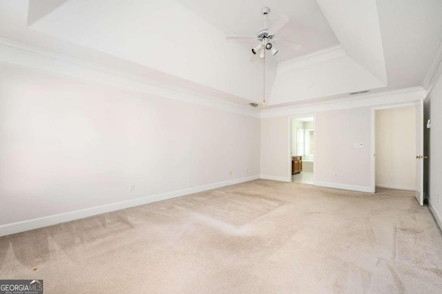 unfurnished room featuring light carpet, ornamental molding, a raised ceiling, and ceiling fan