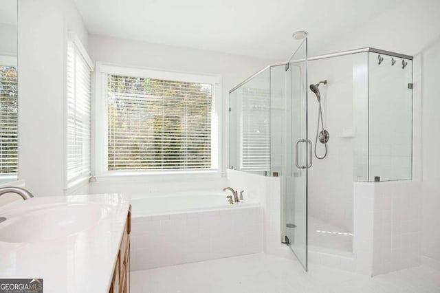 bathroom with vanity and independent shower and bath