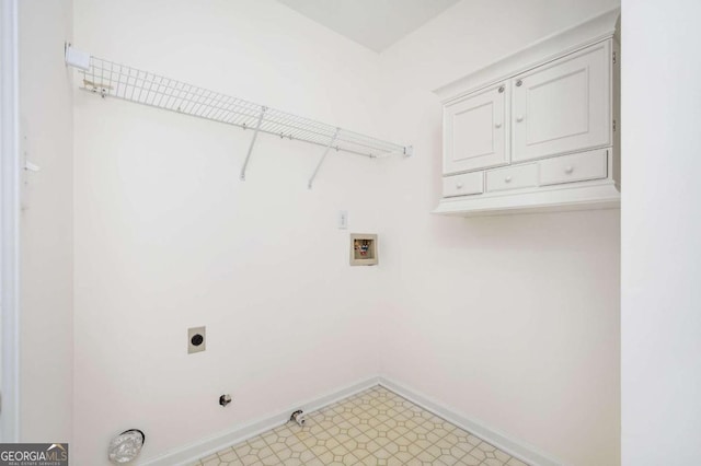 laundry room with washer hookup, hookup for an electric dryer, gas dryer hookup, and cabinets