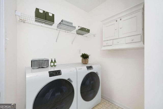 laundry room featuring cabinets and separate washer and dryer