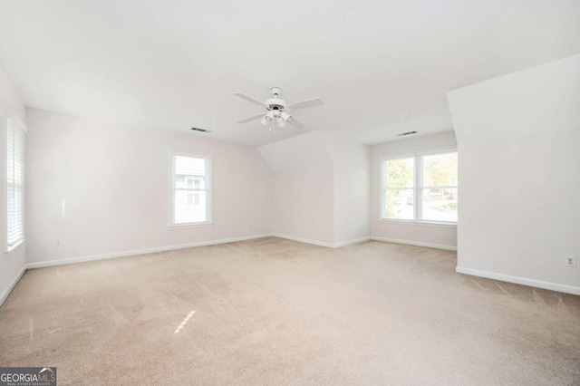 spare room featuring light carpet and plenty of natural light