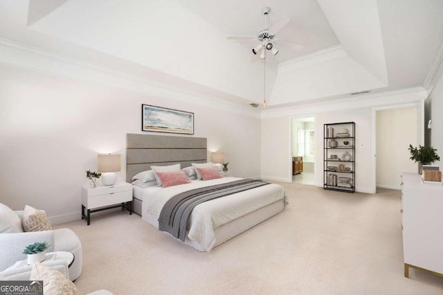 bedroom featuring ceiling fan, ornamental molding, ensuite bathroom, and light colored carpet