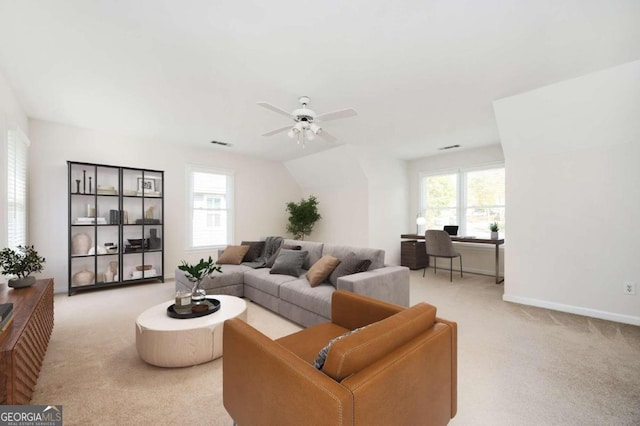 carpeted living room with a wealth of natural light and ceiling fan