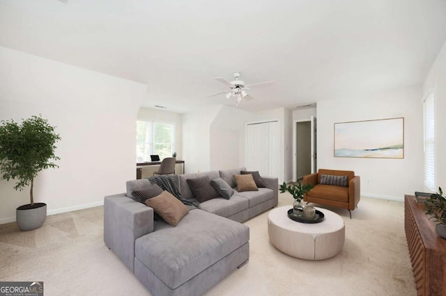 carpeted living room with ceiling fan