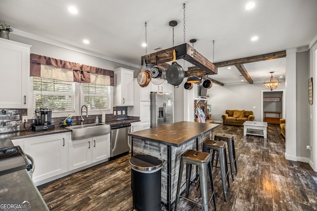 kitchen featuring dark hardwood / wood-style flooring, white cabinetry, sink, and stainless steel appliances