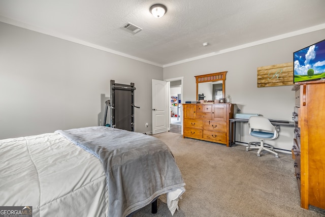 bedroom with ornamental molding, a textured ceiling, a barn door, and light carpet