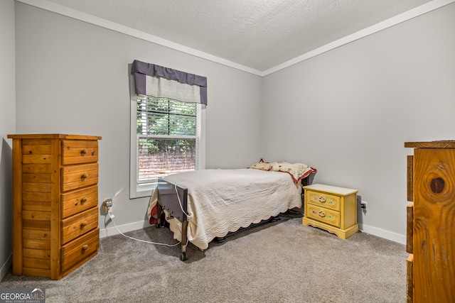 bedroom with a textured ceiling, carpet flooring, and crown molding