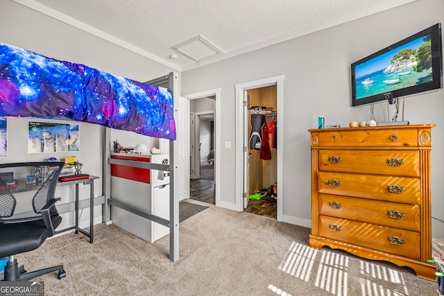 carpeted bedroom featuring a spacious closet, a textured ceiling, and a closet